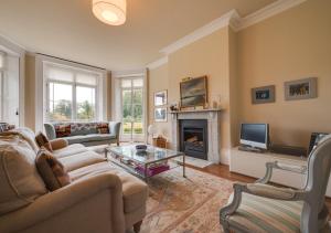 a living room with a couch and a fireplace at The Old Rectory in Haddiscoe