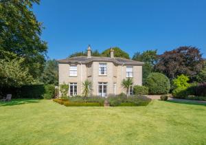 a large house with a large grass yard at The Old Rectory in Haddiscoe