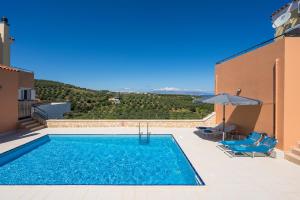 a swimming pool on the roof of a house at Olive Tree Villa in Chania