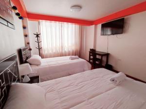 Voodi või voodid majutusasutuse Qolmay Hostel Cusco toas