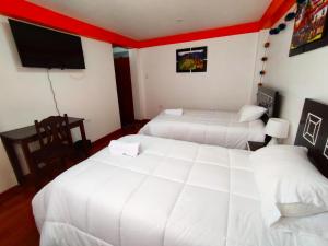 Voodi või voodid majutusasutuse Qolmay Hostel Cusco toas