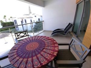 an umbrella sitting on top of a table on a balcony at Holidays in blue in Olhos de Água