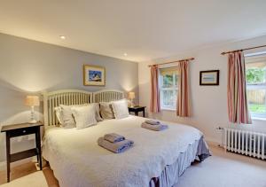 a bedroom with a bed with two towels on it at The Old Mill in Snape