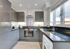 a kitchen with stainless steel appliances and a sink at The Oaks in Laxfield