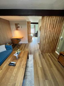 a living room with a blue couch and a table at Suite SZ-Lichtenberg in Salzgitter