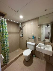 a bathroom with a toilet and a sink at Batu Ferringhi Homestay in Batu Ferringhi