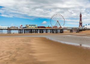 a beach with a ferris wheel and a pier at Beacon Fell View in Longridge