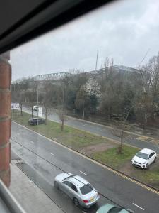 a view of a street with two cars on the road at House in Anfield in Liverpool