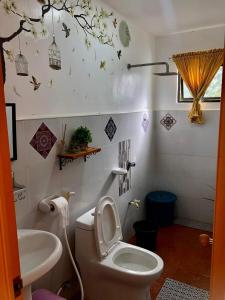 a bathroom with a white toilet and a sink at Dicimulacion Staycation House in Angono