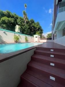 a staircase leading to a building with a swimming pool at Odyssey Allure in Kingston