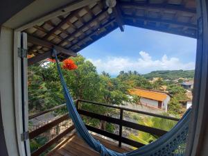 a hammock in a room with a view from a window at Stay Cool Pipa in Pipa