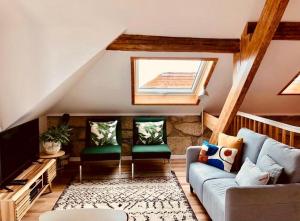 a living room with a couch and a television at Lobo do Mar Matosinhos Beach Loft in Matosinhos