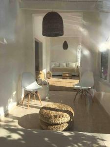 a living room with two chairs and a couch at Private beautiful house - ( nice swimming Pool) in Cala'n Porter