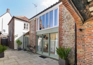 an extension to a brick house with glass doors at The Maltings in Southwold