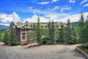 a large building with a lot of trees in front of it at The Pines Lodge, a RockResort in Beaver Creek