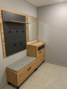 a dressing room with a wooden dresser and a mirror at Hygge Apartment in Mizhhirya