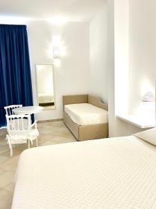 a bedroom with a bed and a table and a couch at Balconcino d'Oriente in Otranto