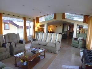 ein Wohnzimmer mit Sofas und einem Couchtisch in der Unterkunft Estancia La Quinta in El Chalten