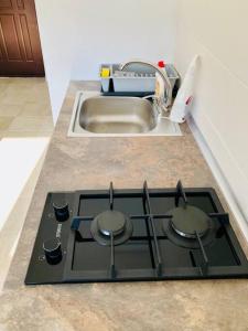 a stove top in a kitchen next to a sink at Joy City Stay Victoriei 7G-9 in Timişoara
