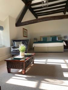 a living room with a bed and a coffee table at The Groom's Cottage in Towcester