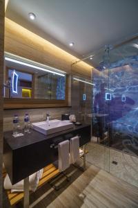 a bathroom with a sink and a glass shower at Renaissance Cancun Resort & Marina in Cancún