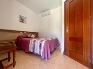 Postel nebo postele na pokoji v ubytování Hostal Noli