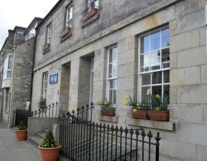 a building with potted plants on the side of it at The Albany St Andrews in St Andrews