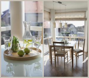 a kitchen and dining room with a table with a vase at Nora Green in Nida