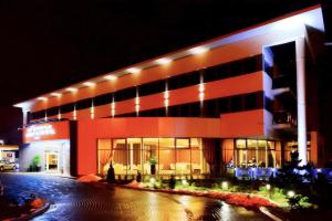 a large building with lights on it at night at Hotel Business Faltom Gdynia in Gdynia