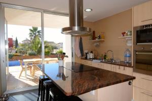 a kitchen with a counter top with a view of a patio at Ponent in L'Escala