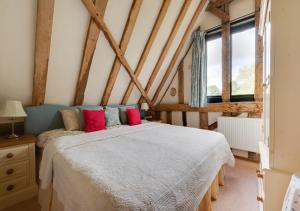 a bedroom with a bed and two windows at Wattisham Hall Barns in Wattisham