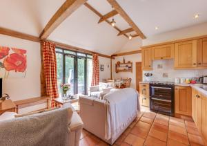 a kitchen with wooden cabinets and a counter top at Wattisham Hall Barns in Wattisham