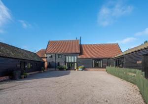 a house with two buildings and a driveway at Wattisham Hall Barns in Wattisham