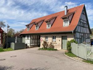 a black and white house with a red roof at Ferienhaus Hassgautor in Aidhausen