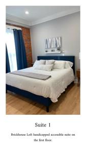 A bed or beds in a room at Brickhouse Loft - a boutique hotel
