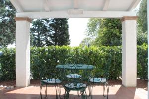 a patio with a table and four chairs on a patio at Casa Bianca Stella in Numana