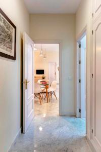 a door leading into a dining room with a table at Genteel Home Tomás de Ibarra in Seville