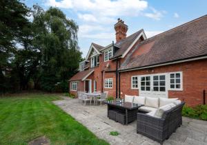 a brick house with a patio in the yard at Tower Cottage in Walberswick
