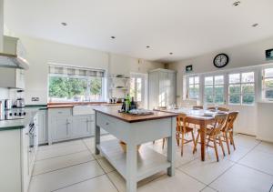 a kitchen with a table and a dining room at Tower Cottage in Walberswick