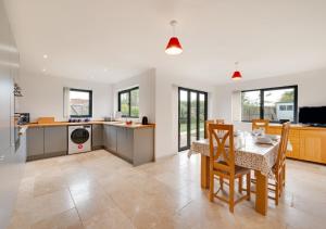 a kitchen and dining room with a table and chairs at West View in Middleton