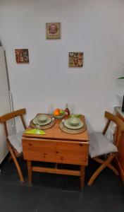 a table with two chairs and a bowl of fruit on it at Lisbon apartment in Lisbon