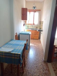 a small kitchen with a table and a sink at Villa Froso in Pefki