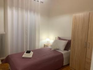 a bedroom with a bed with a book on it at Diamanto's Home in Kastanéa