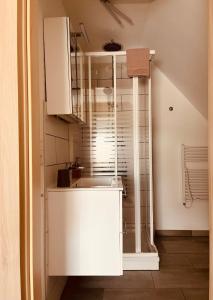 a white kitchen with a sink and a window at Hotel Pension garni Haus am Strand 2 in Norddeich +29 photos
