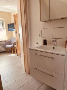 a kitchen with a sink and a counter top at Hotel Pension garni Haus am Strand 2 in Norddeich