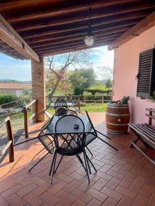 a patio with a table and chairs on a patio at I Puntoni Agriturismo in Magliano in Toscana