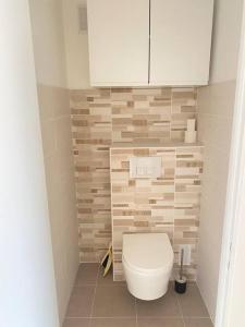 a bathroom with a toilet and a white cabinet at Walk to Beach T2 Climatisé, Vue mer, Parking Privé in Roquebrune-Cap-Martin