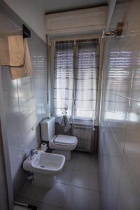 a bathroom with a toilet and a sink at La maison di Roberto in La Spezia