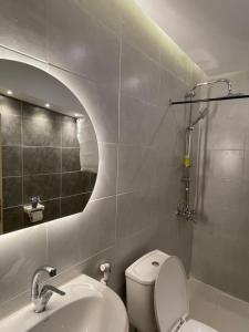 a bathroom with a toilet and a sink and a shower at RoadHouse - Petra in Wadi Musa +111 photos