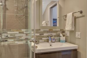 a bathroom with a sink and a shower at 311 Water Street Inn in Boyne City